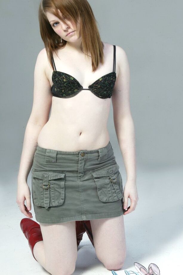 20P Pale redhead Lilly slowly strips to a black G-string and red leather boots