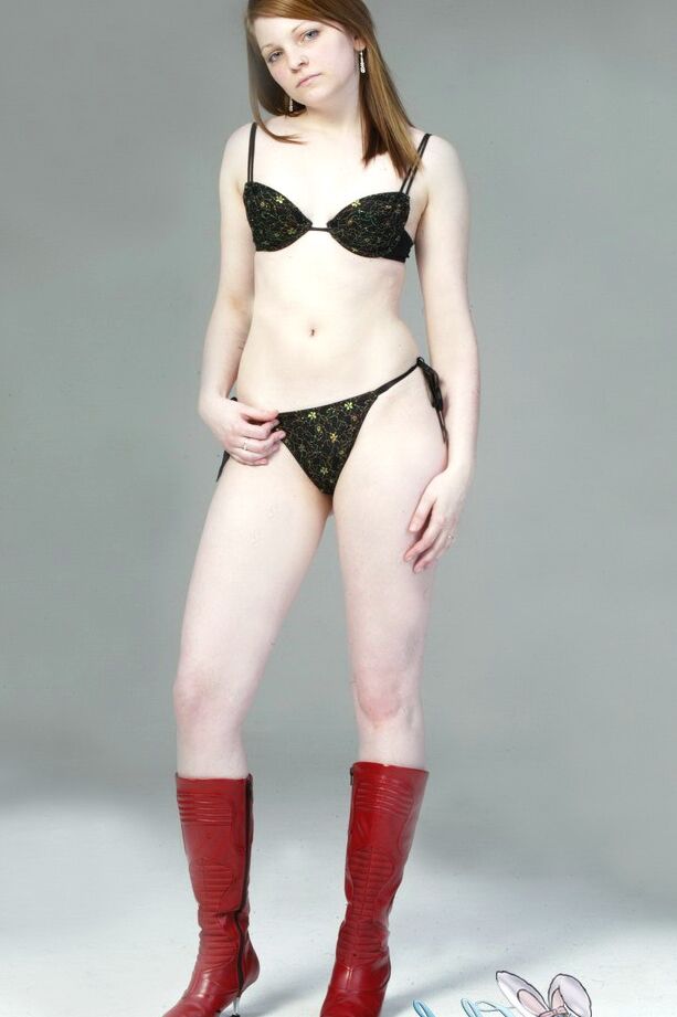 20P Pale redhead Lilly slowly strips to a black G-string and red leather boots