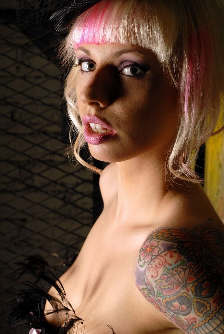15P La modelo amateur Lynn Pops luce el pelo teñido con un corsé y medias de nailon