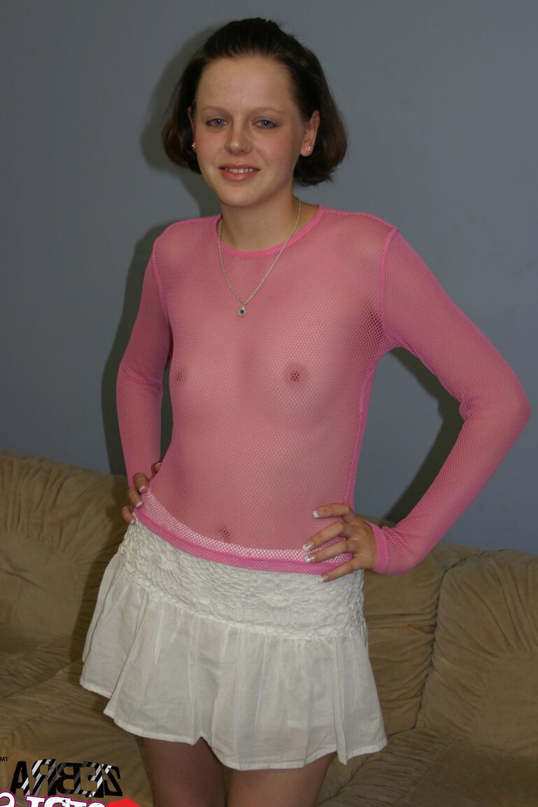 17P American solo girl shows off her bare ass in a see thru top on a couch