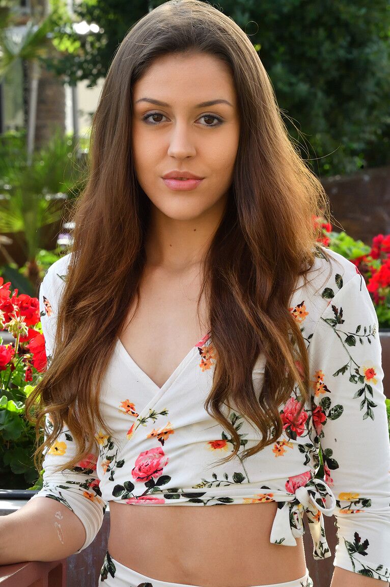 15P Amateur model Catalina sports a no panty upskirt while on a garden path