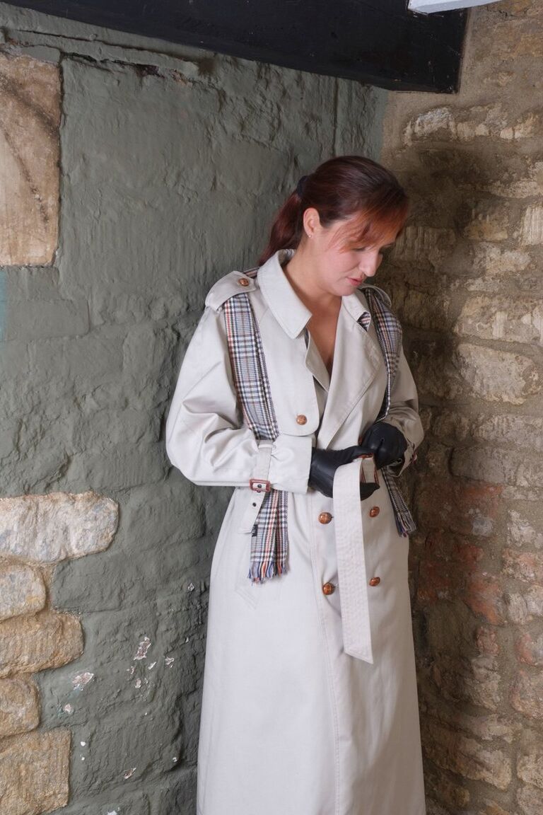 15P Redhead woman Sammy frees her small tits from trench coat in leather gloves