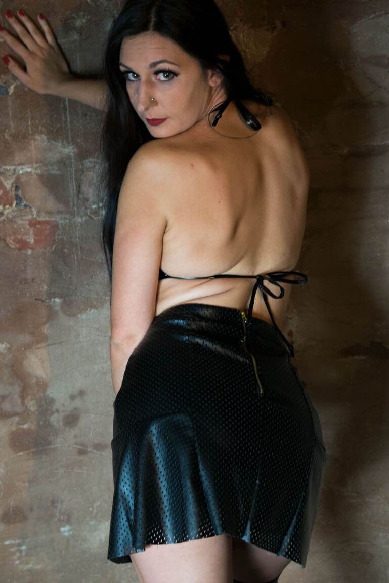 15P British model Sophie Garcia sticks out her pierced tongue in latex fetish wear