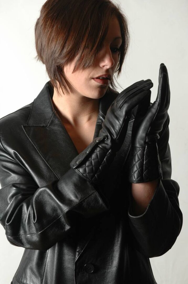 15P Fully clothed female pulls on a pair of black leather gloves