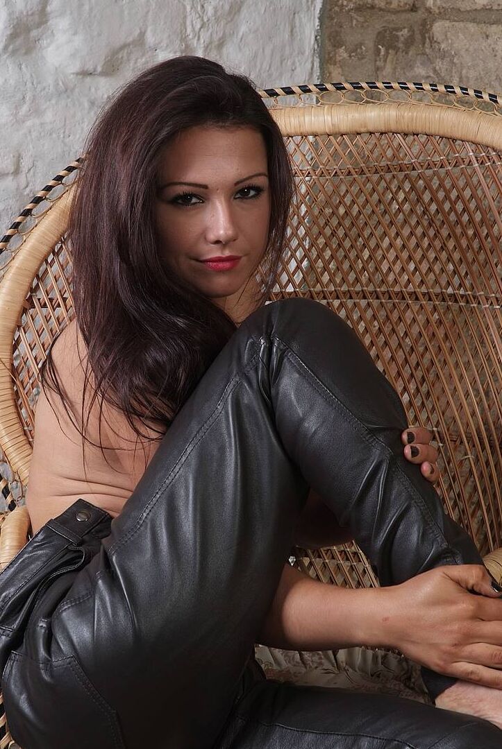 15P Sexy brunette models models black leather pants while topless in bare feet