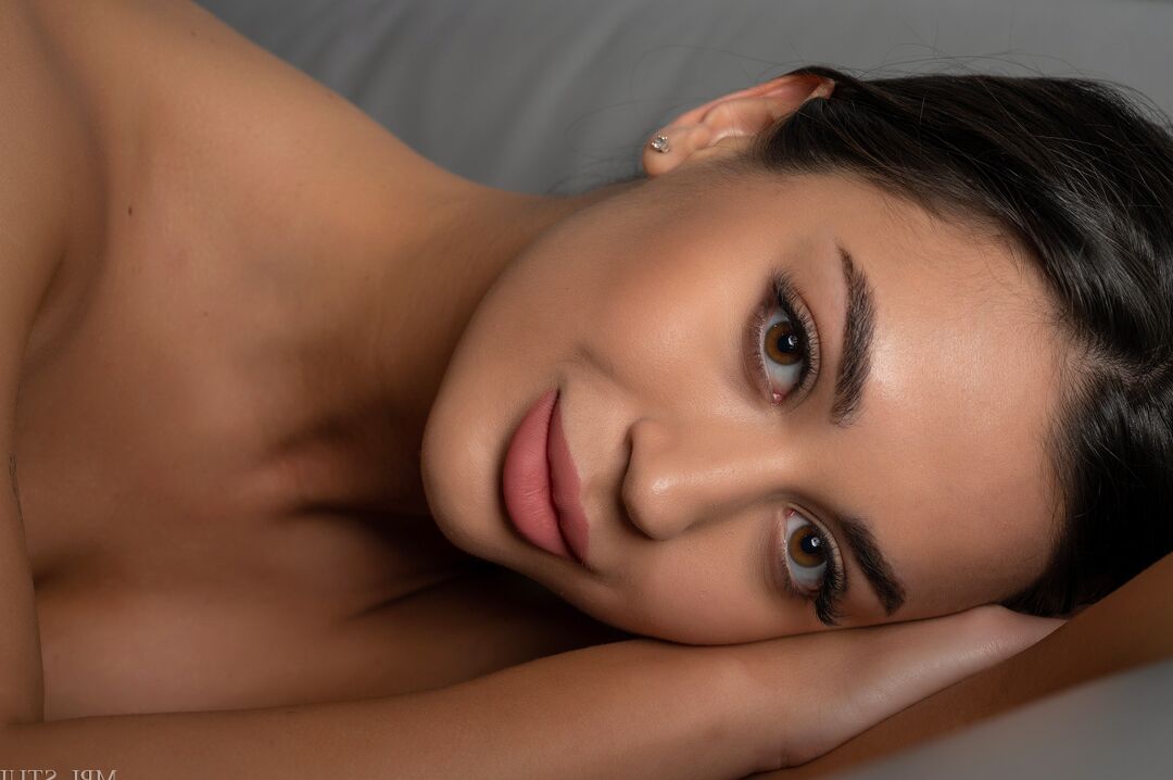 12P Gorgeous brunette models totally naked on a leather loveseat