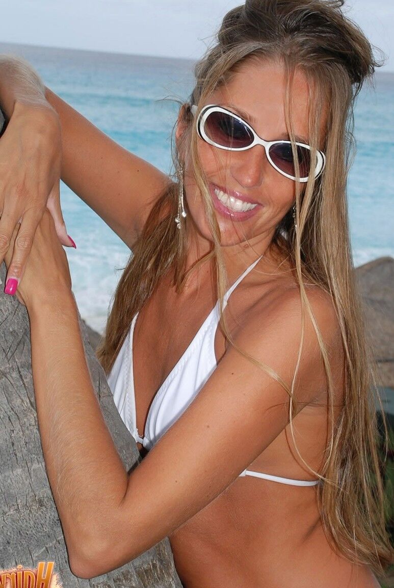 15P Long-legged amateur Lori Anderson models a bikini in shades next to a tree