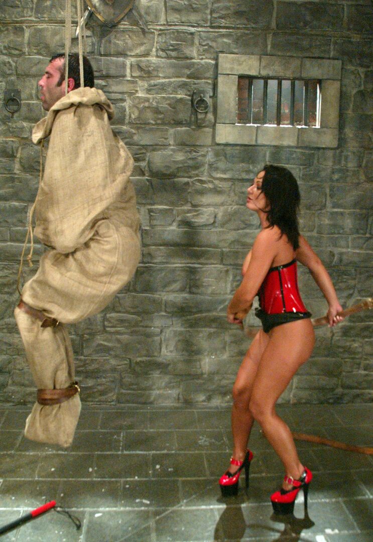 17P Brunette Domme Sandra Romain suspends a man in a bag before beating him