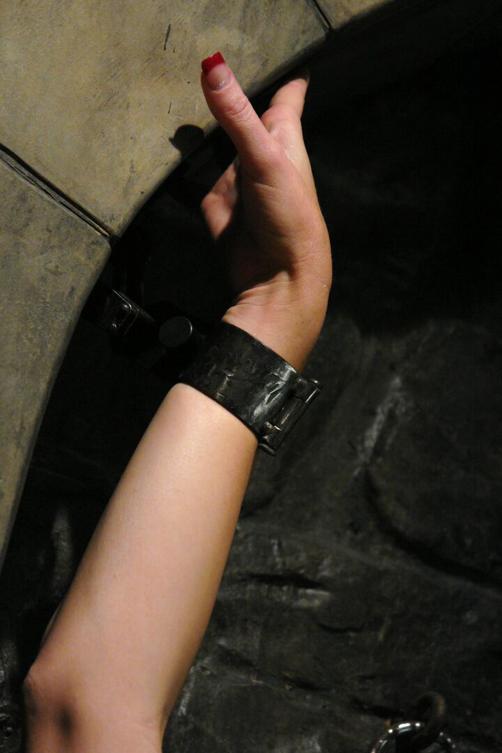 17P Hot Adrianna Nicole in latex & gag shackled to dungeon wall for BDSM playtime