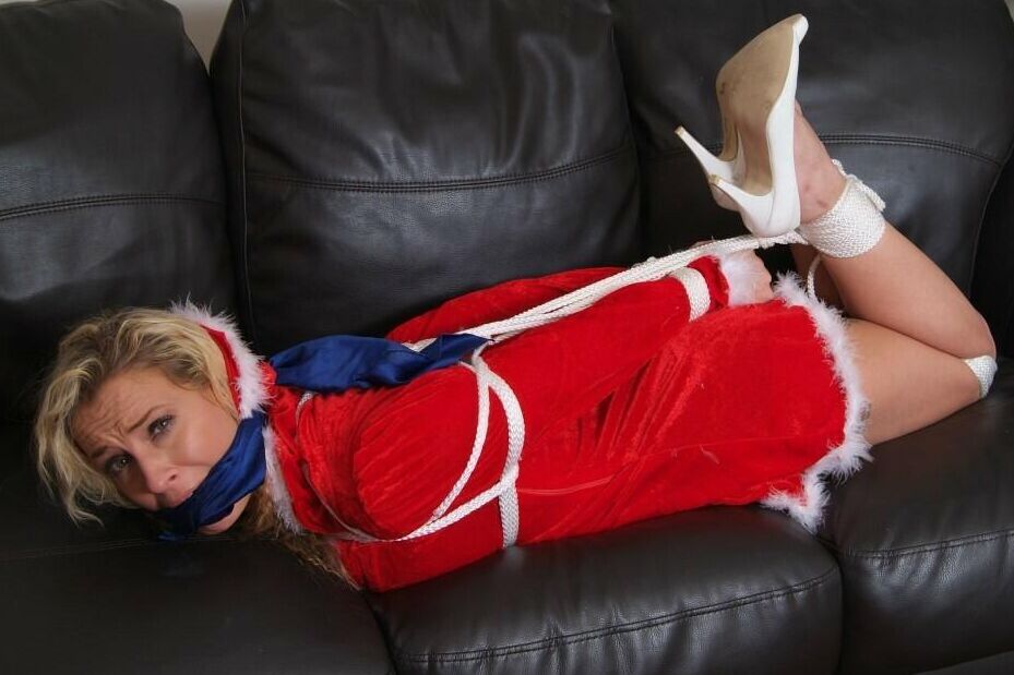 16P Blonde chick Katie C is cleave gagged and hogtied in Christmas attire