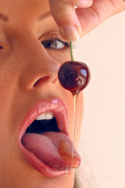 15P Pretty girl Sandra Shine curls her tongue while sucking juice from a cherry