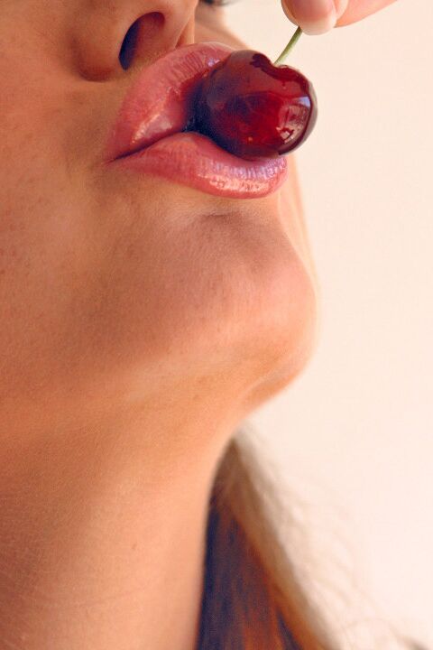 15P Pretty girl Sandra Shine curls her tongue while sucking juice from a cherry