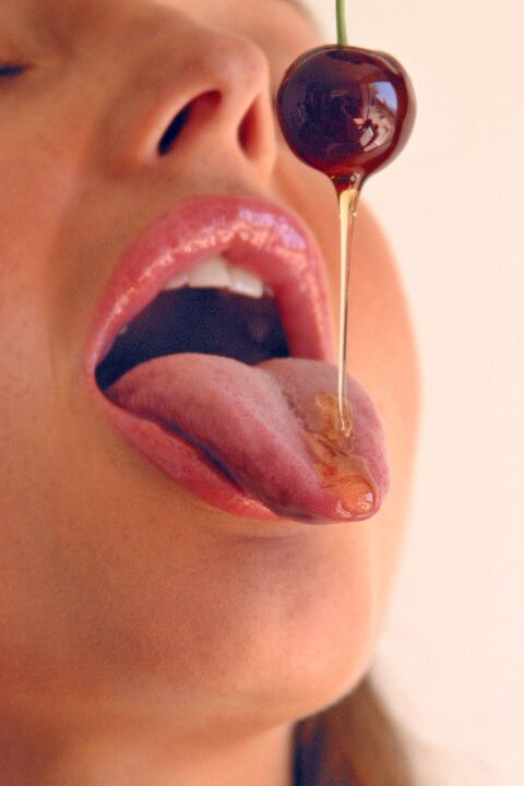 15P Pretty girl Sandra Shine curls her tongue while sucking juice from a cherry