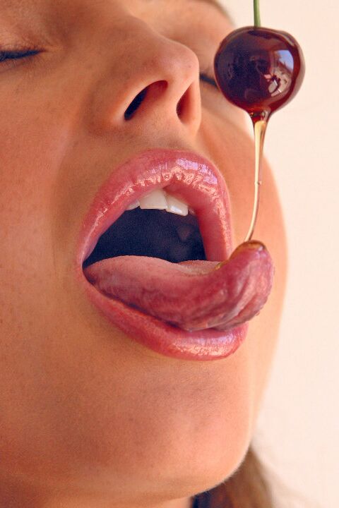 15P Pretty girl Sandra Shine curls her tongue while sucking juice from a cherry