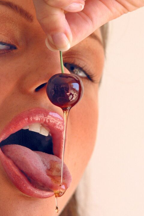 15P Pretty girl Sandra Shine curls her tongue while sucking juice from a cherry