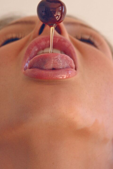 15P Pretty girl Sandra Shine curls her tongue while sucking juice from a cherry