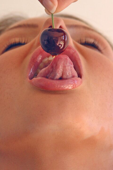 15P Pretty girl Sandra Shine curls her tongue while sucking juice from a cherry