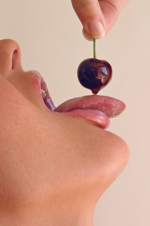 15P Pretty girl Sandra Shine curls her tongue while sucking juice from a cherry
