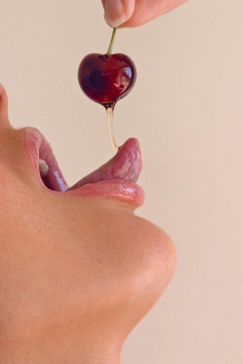 15P Pretty girl Sandra Shine curls her tongue while sucking juice from a cherry