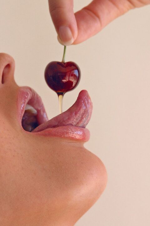 15P Pretty girl Sandra Shine curls her tongue while sucking juice from a cherry