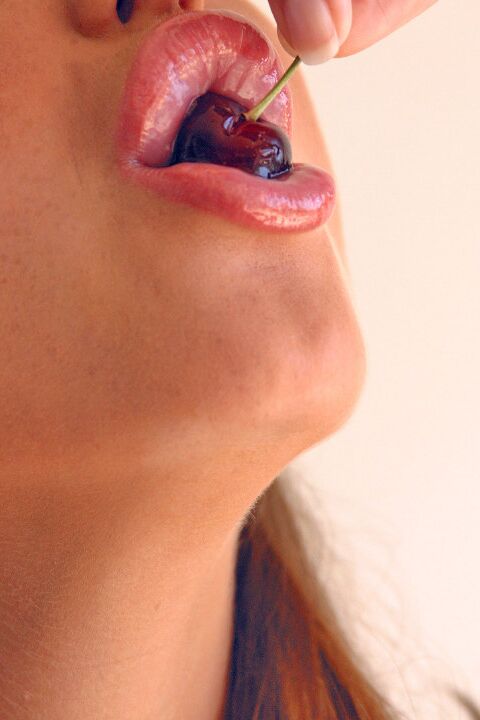 15P Pretty girl Sandra Shine curls her tongue while sucking juice from a cherry