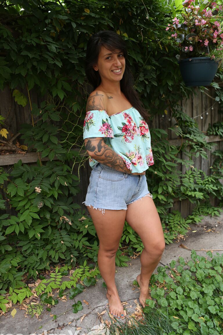 16P Brunette amateur Liandra Dahl tugs on a nip before showing her cunt by a tree