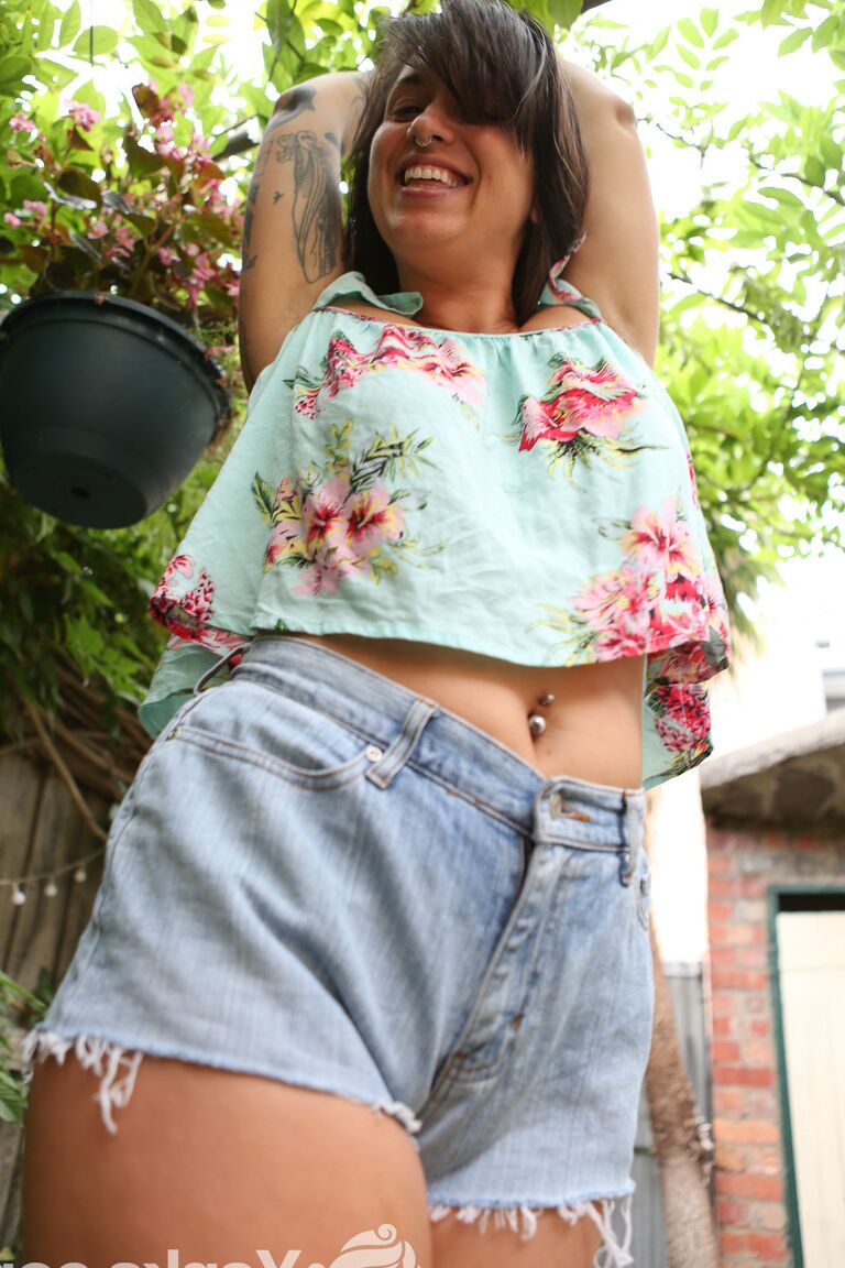 16P Brunette amateur Liandra Dahl tugs on a nip before showing her cunt by a tree