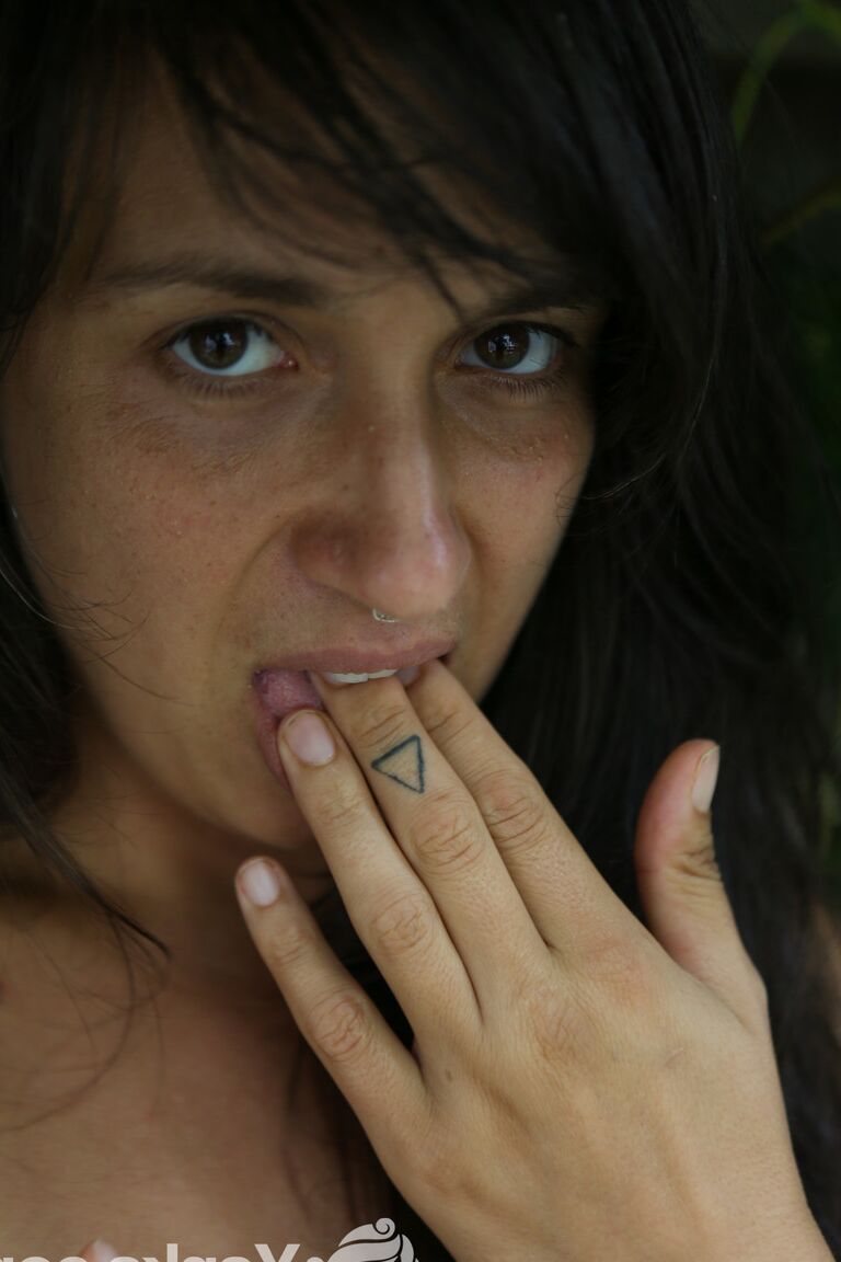 16P Brunette amateur Liandra Dahl tugs on a nip before showing her cunt by a tree