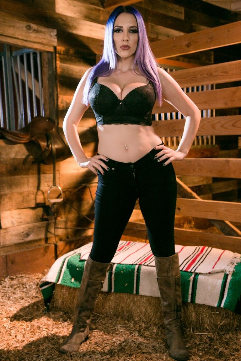 15P One of two girls exposes her breasts while they are in a horse stall