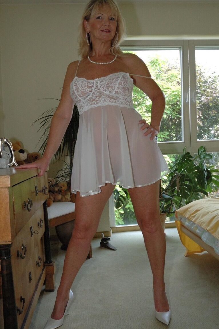12P Busty blonde Marlen posing in a white negligee in the bedroomBig