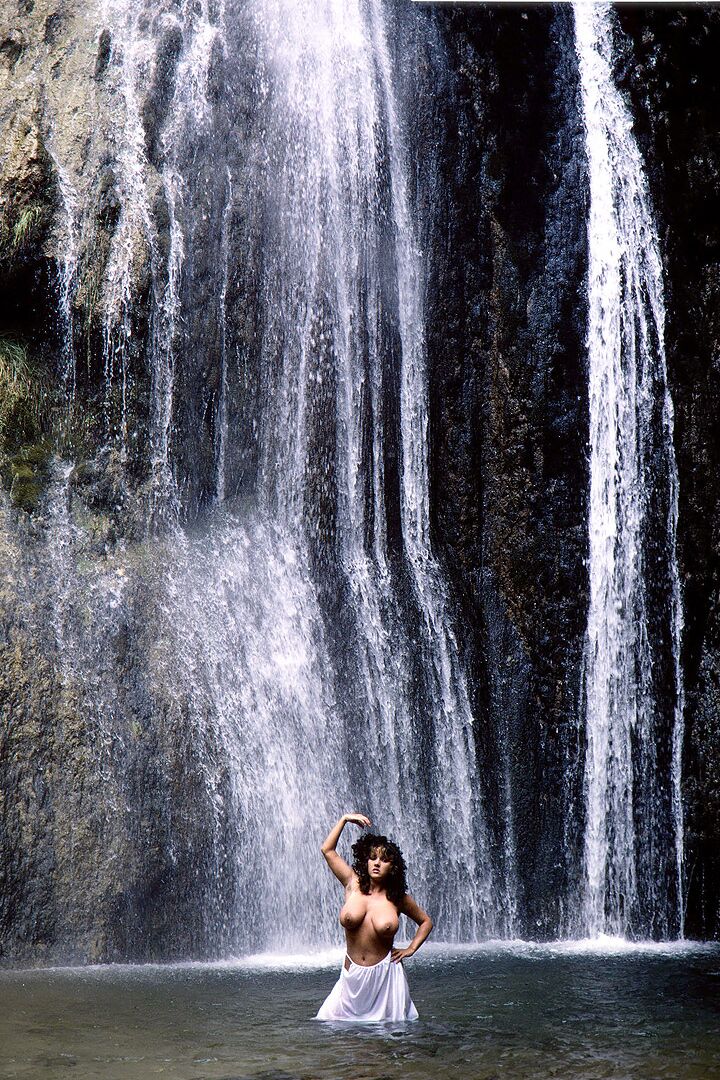 16P Solo girl Stacy Owen displays her huge breasts in front of a waterfall