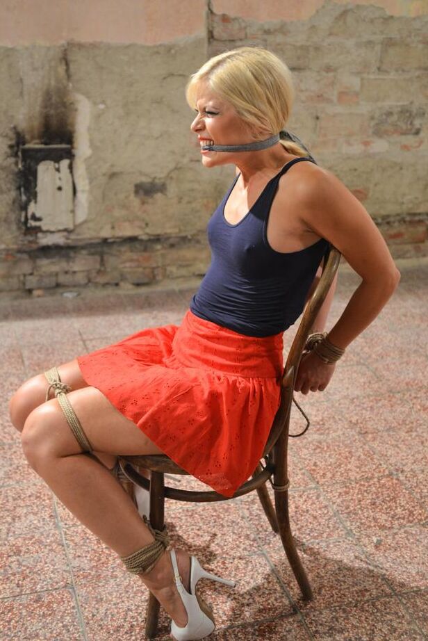 16P Blonde female Sandy struggles after being gagged and tied to a chair