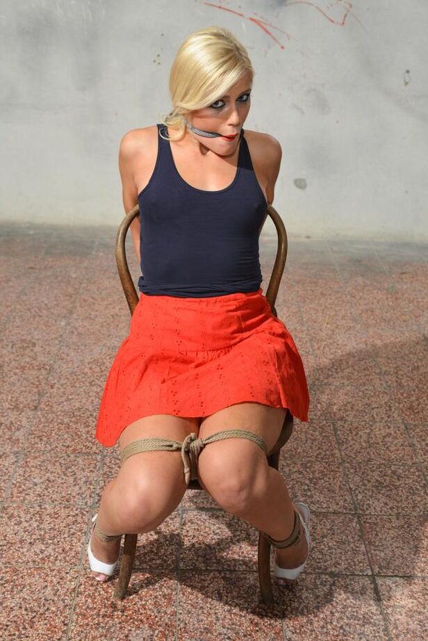 16P Blonde female Sandy struggles after being gagged and tied to a chair