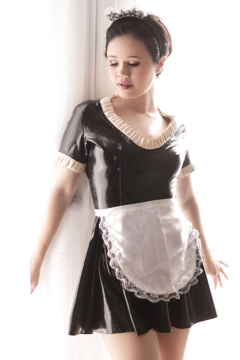 15P Stunning young maid Yhivi slips off uniform to model naked in the window