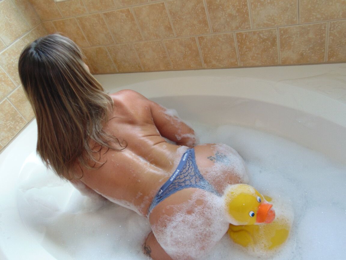 13P Charming mom with pierced nipples Flower sucks a toy during a bubble bath