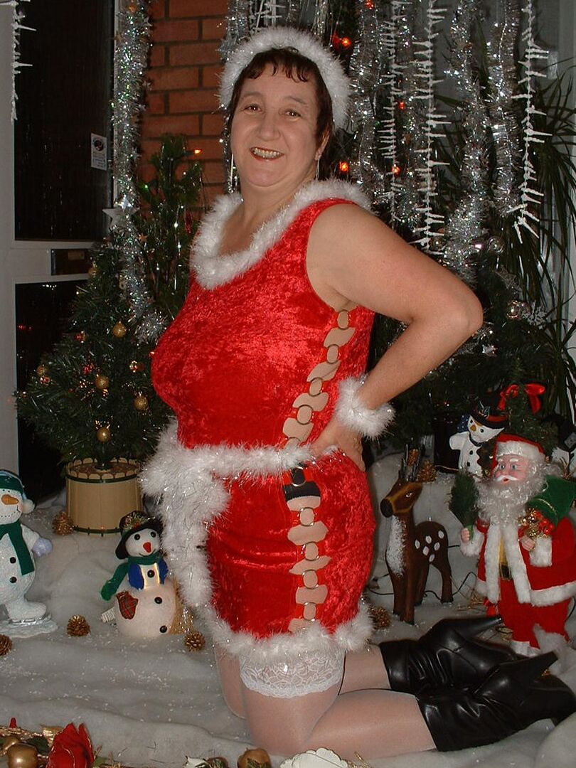 16P Mature redhead Kinky Carol uncovers her large breasts in front of an Xmas tree