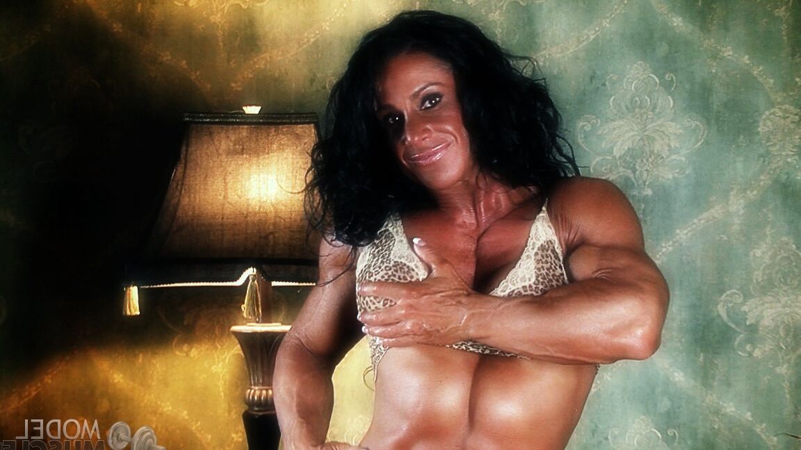 21P Sexy bodybuilder Debbie Bramwell teases with her muscles and pierced belly