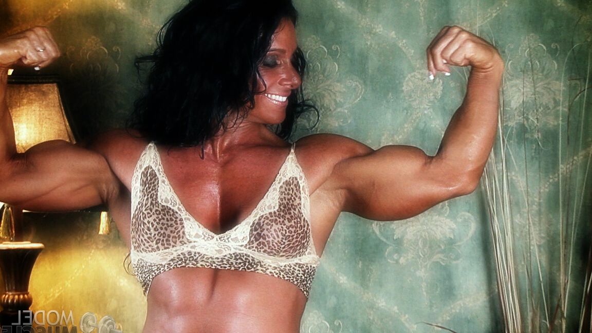 21P Sexy bodybuilder Debbie Bramwell teases with her muscles and pierced belly