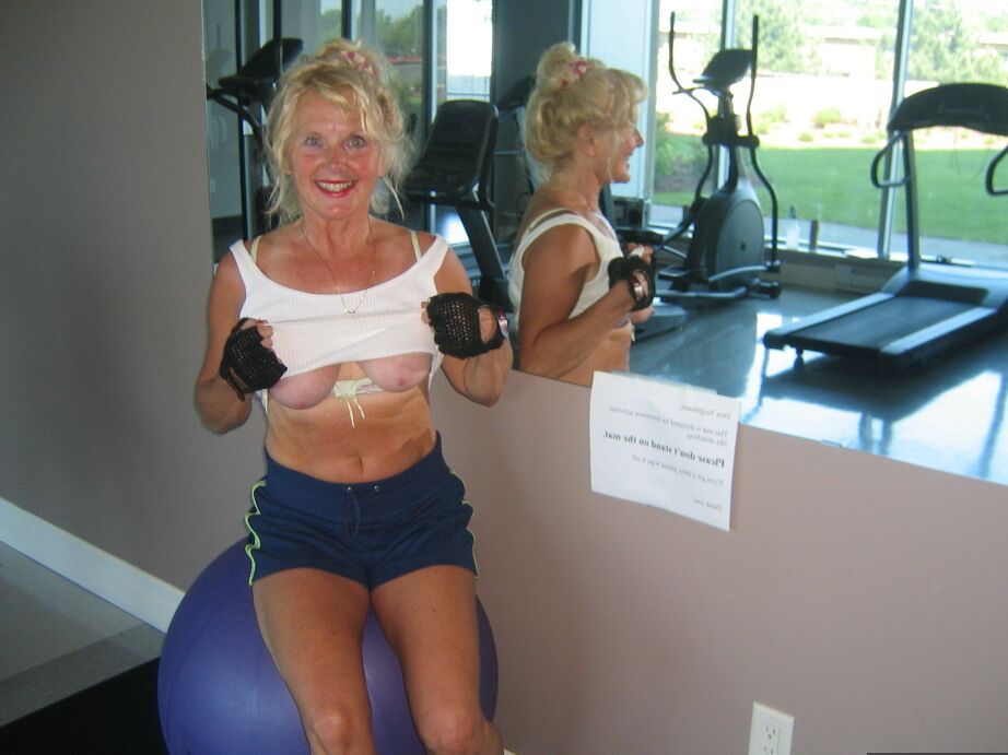 20P Mature blonde Ruth uncovers her breasts while working out at a gym