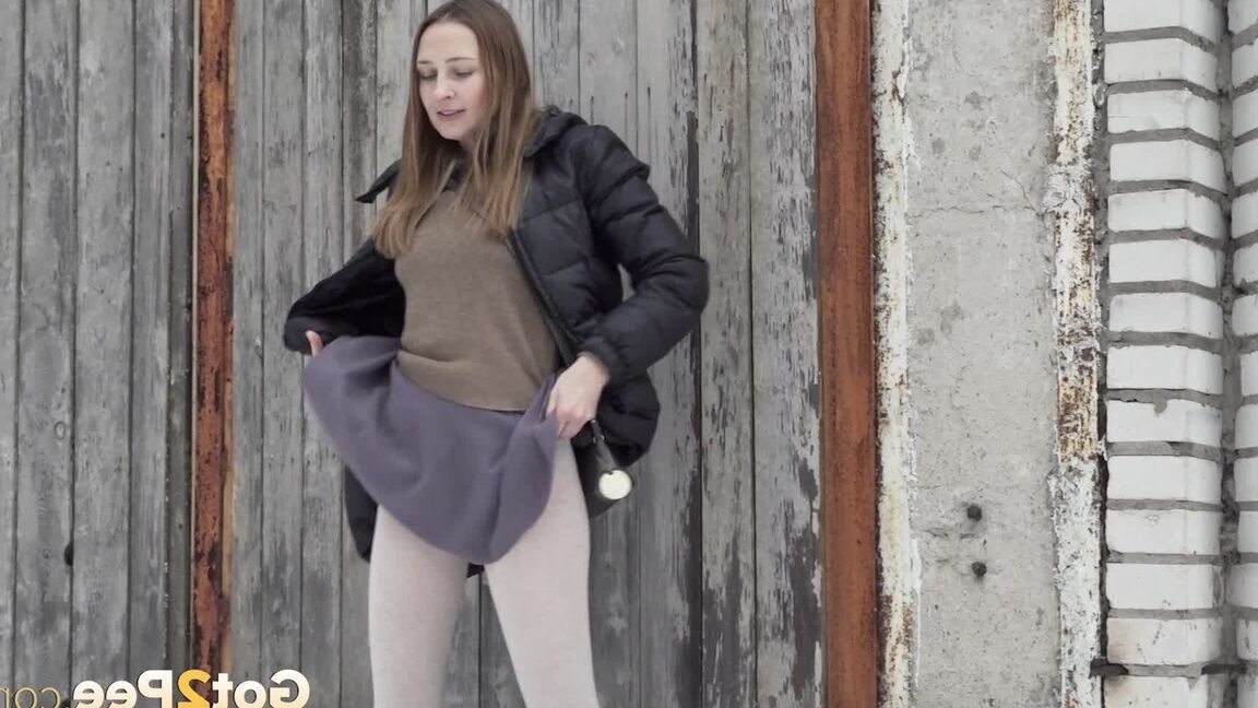 15P Caucasian girl Valya takes a piss in the snow after ducking behind a building