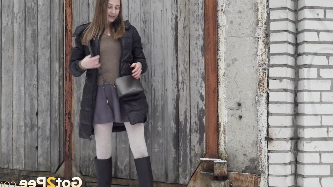 15P Caucasian girl Valya takes a piss in the snow after ducking behind a building