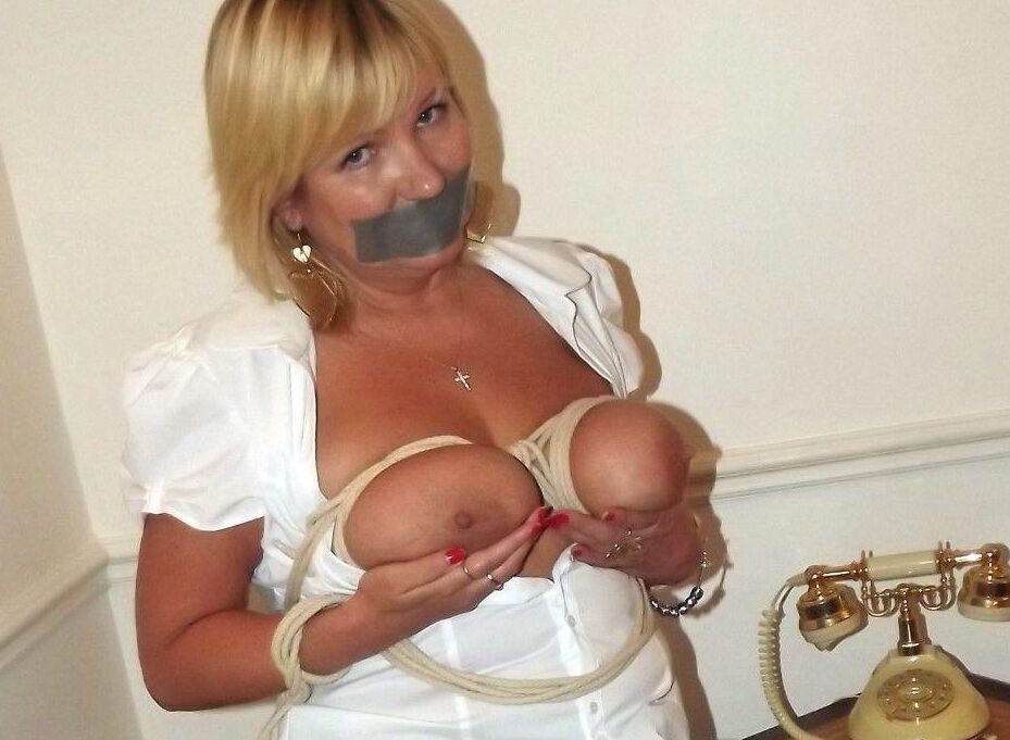 15P Blonde woman is restrained, gagged and blindfolded in various locations