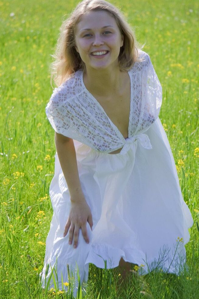 15P Young blonde Pocahontas flashes in a field while wearing see thru clothing