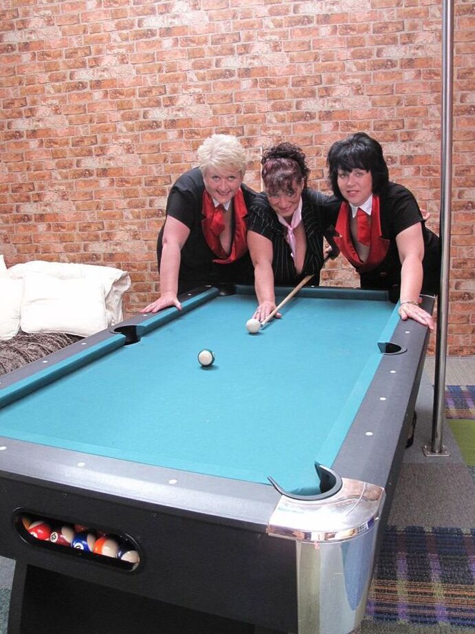 20P Busty older woman and two of her girlfriends blow a naked man on a pool table