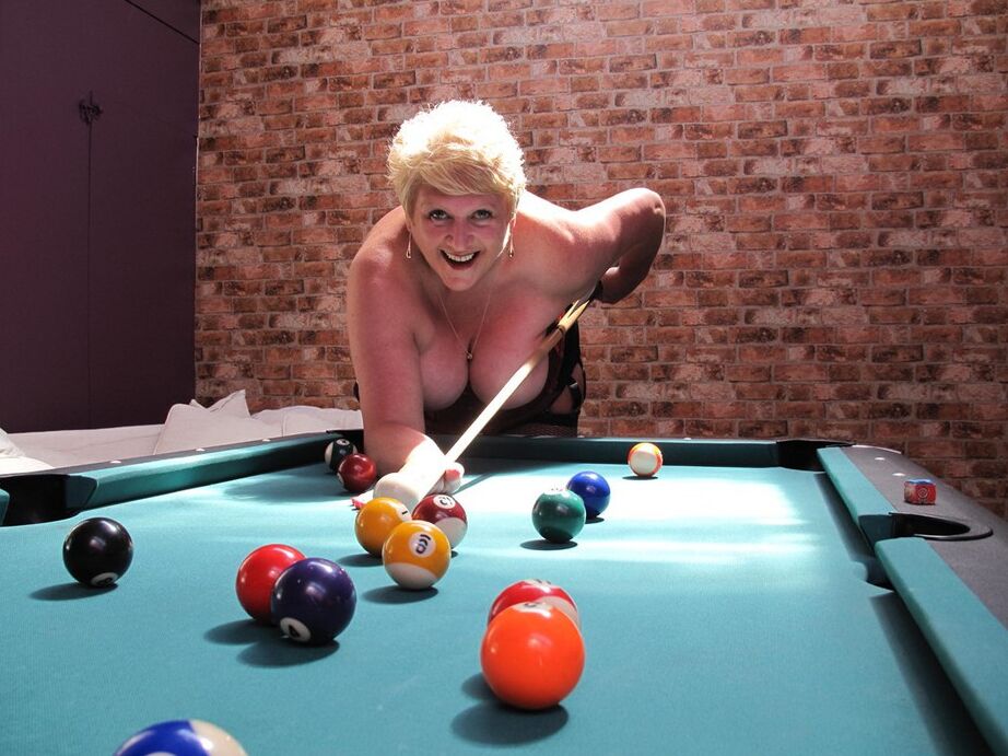 20P Busty older woman and two of her girlfriends blow a naked man on a pool table