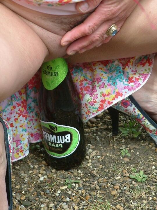 12P Old British woman squats atop a beer bottle while masturbating in public
