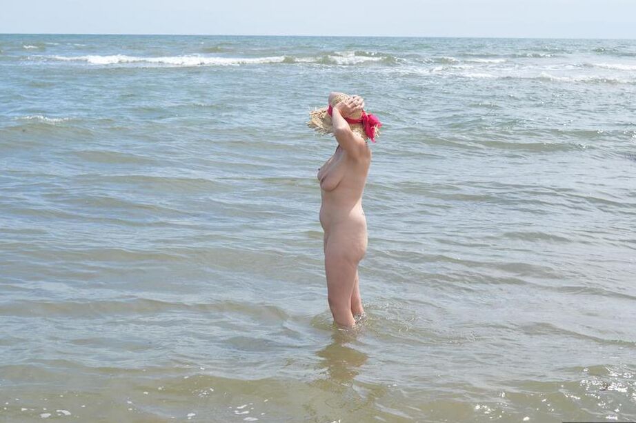 20P Older amateur Barby Slut wades into the ocean in nothing more than a sun hat