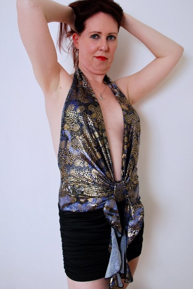 20P Mature redhead in a black skirt and heels strips in her nude modeling debut
