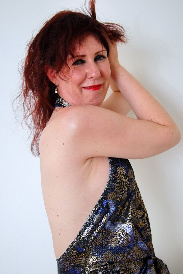 20P Mature redhead in a black skirt and heels strips in her nude modeling debut