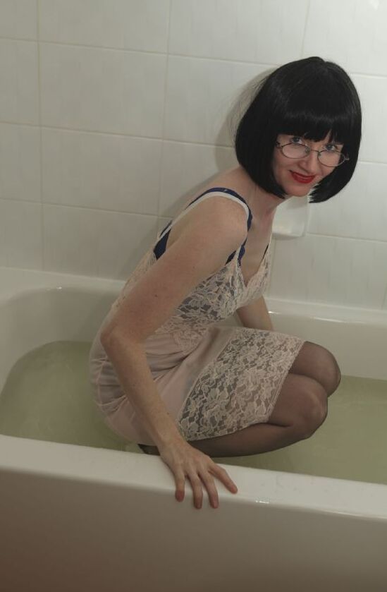 12P Dressed mature lady in black nylon stockings taking a bath
